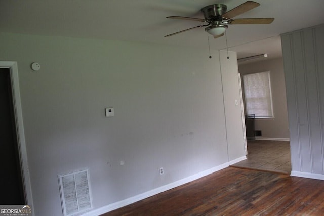 empty room featuring wood-type flooring and ceiling fan