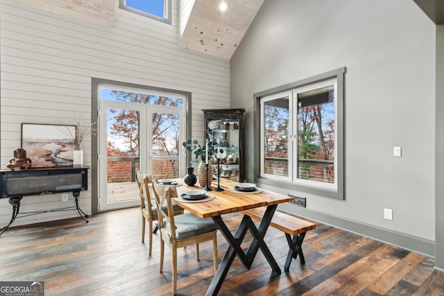 dining space featuring high vaulted ceiling and dark hardwood / wood-style floors