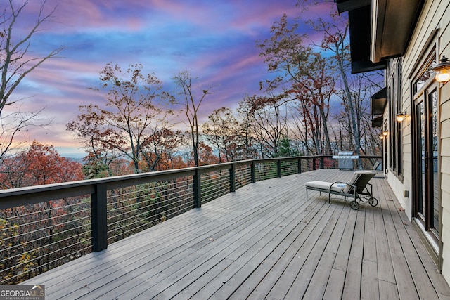 deck at dusk with a grill