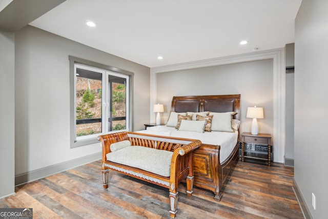 bedroom with dark wood-type flooring