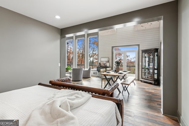 bedroom featuring wood-type flooring and access to exterior