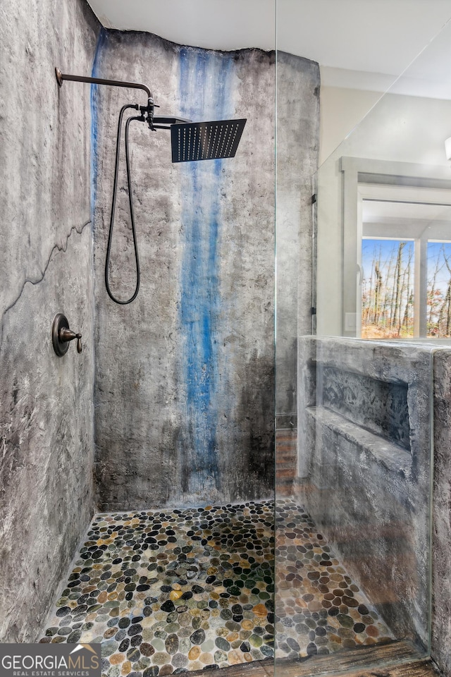 bathroom with tiled shower