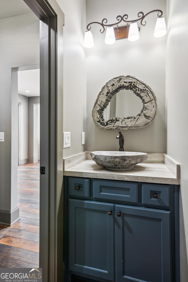 bathroom with hardwood / wood-style flooring and vanity