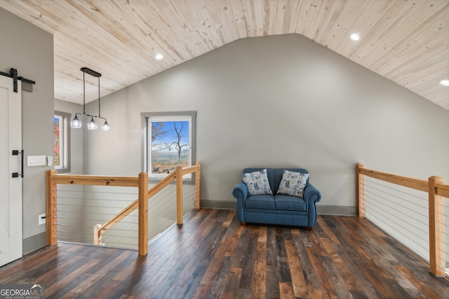 sitting room with dark hardwood / wood-style flooring, a barn door, vaulted ceiling, and wood ceiling