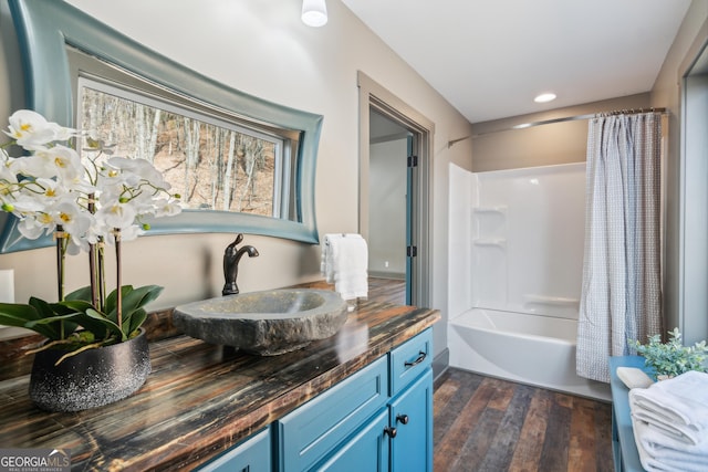 bathroom with shower / tub combo with curtain, vanity, and hardwood / wood-style flooring