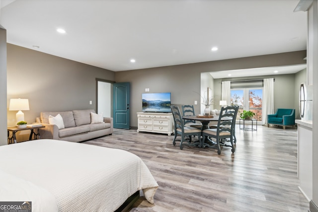 bedroom featuring light hardwood / wood-style flooring and access to outside