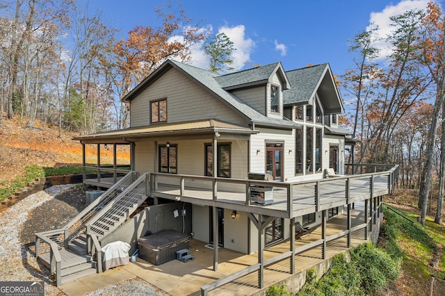 view of front facade featuring a wooden deck and a hot tub