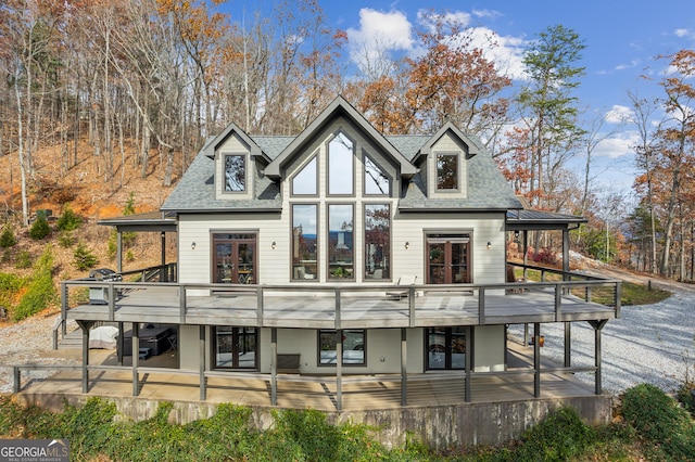 rear view of property with a wooden deck