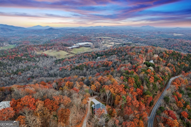 aerial view at dusk featuring a mountain view