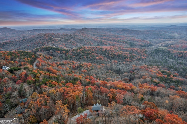 aerial view at dusk featuring a mountain view