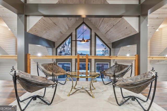 living area with hardwood / wood-style floors, high vaulted ceiling, and wooden ceiling