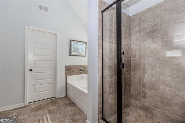 bathroom featuring tile patterned flooring, plus walk in shower, and lofted ceiling