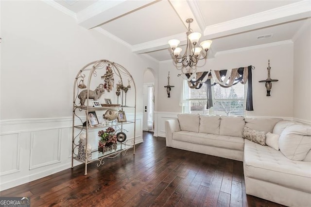 living room with beam ceiling, dark hardwood / wood-style flooring, a chandelier, and ornamental molding