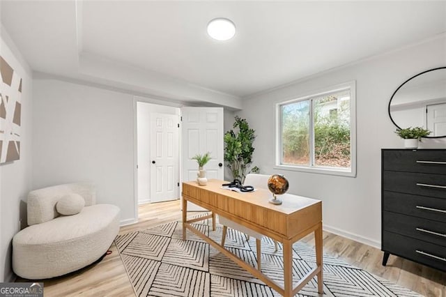 home office with light hardwood / wood-style floors