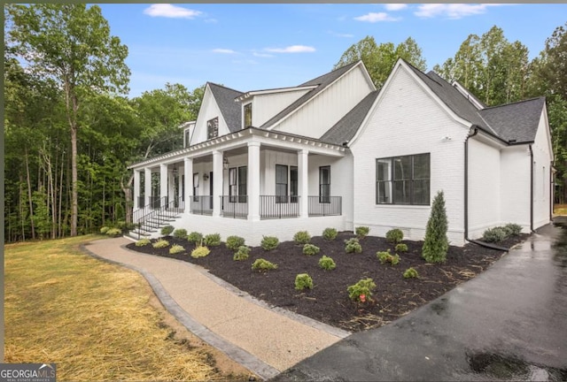 view of property exterior featuring covered porch and a yard