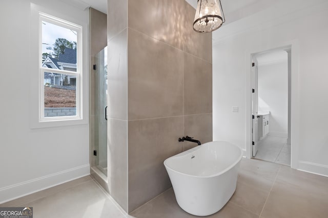 full bathroom featuring a freestanding bath, tile patterned flooring, a shower stall, and a wealth of natural light