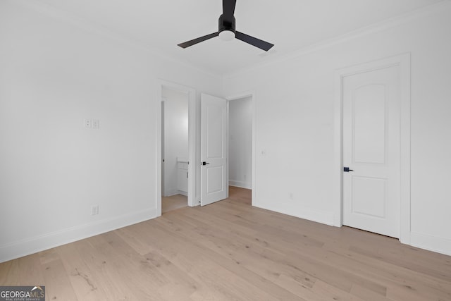 unfurnished bedroom with ornamental molding, ceiling fan, light wood-style flooring, and baseboards