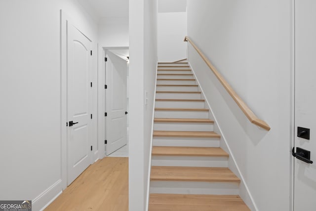 stairway with wood finished floors