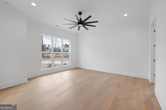 spare room featuring recessed lighting, light wood-style flooring, ornamental molding, ceiling fan, and baseboards