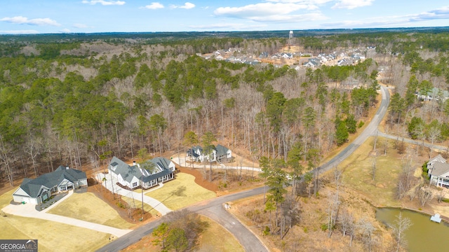 bird's eye view with a water view and a wooded view