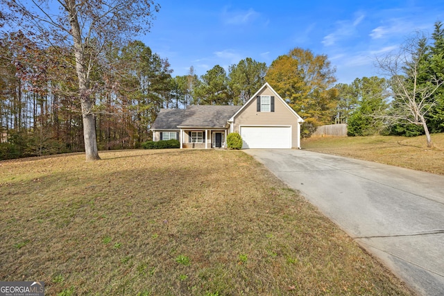 view of front of property featuring a front yard and a garage