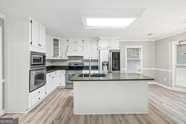 kitchen featuring white cabinetry, stainless steel appliances, and a kitchen island with sink