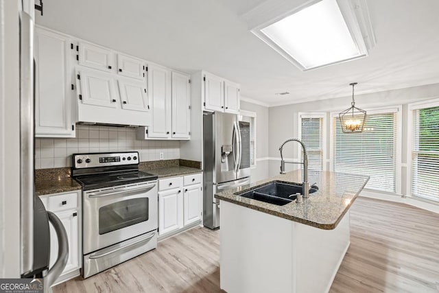 kitchen featuring white cabinets, sink, light wood-type flooring, an island with sink, and appliances with stainless steel finishes