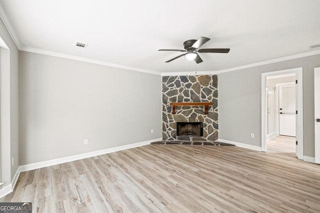 unfurnished living room with light hardwood / wood-style floors, crown molding, and a fireplace