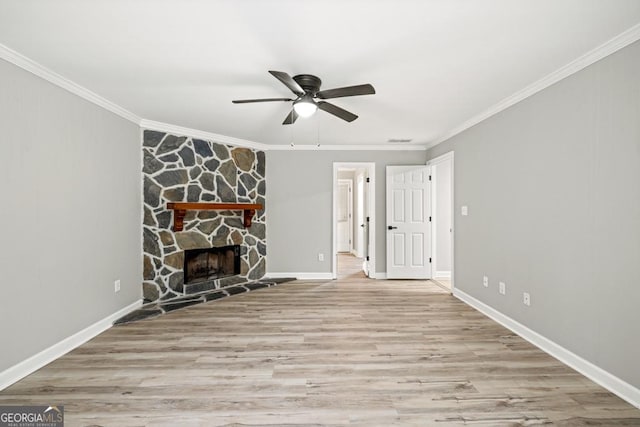 unfurnished living room with a fireplace, crown molding, light hardwood / wood-style flooring, and ceiling fan