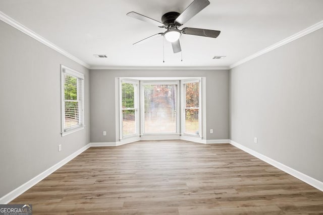 unfurnished room with hardwood / wood-style flooring, ceiling fan, and ornamental molding