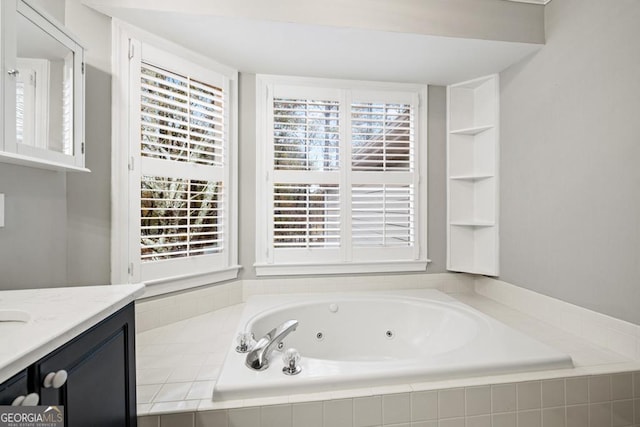 bathroom featuring vanity and tiled bath