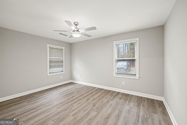 spare room with light wood-type flooring and ceiling fan