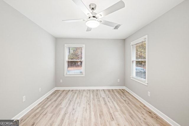 unfurnished room featuring ceiling fan, a healthy amount of sunlight, and light wood-type flooring