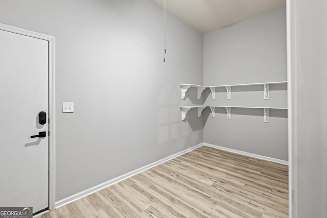 spacious closet with light hardwood / wood-style flooring