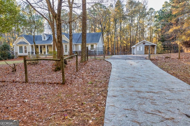 view of front of home with covered porch, an outdoor structure, and a garage