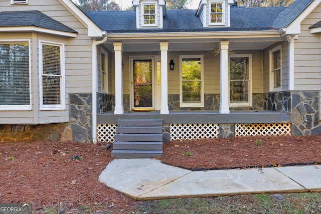 doorway to property featuring ceiling fan and a porch