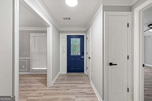 doorway with ceiling fan, light wood-type flooring, and crown molding