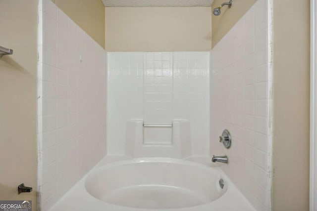 bathroom featuring shower / bath combination and a textured ceiling