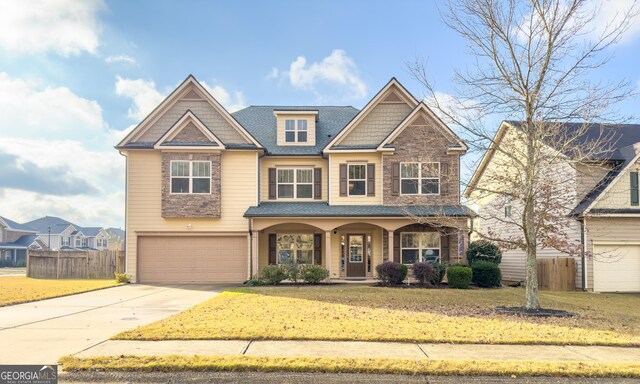 view of front of home featuring a front yard and a garage