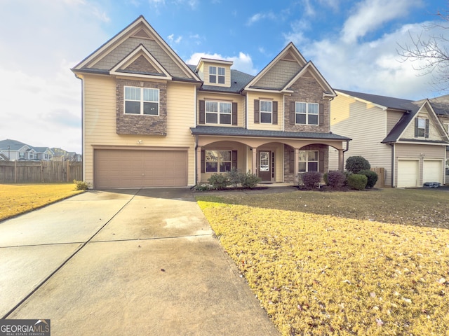 view of front of house with a front lawn, a porch, and a garage