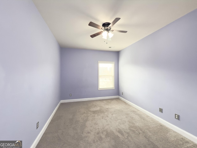 empty room featuring ceiling fan and carpet floors