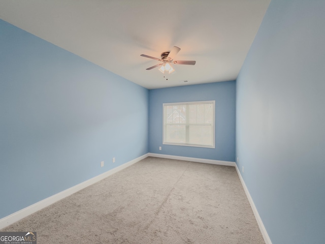 carpeted spare room with ceiling fan