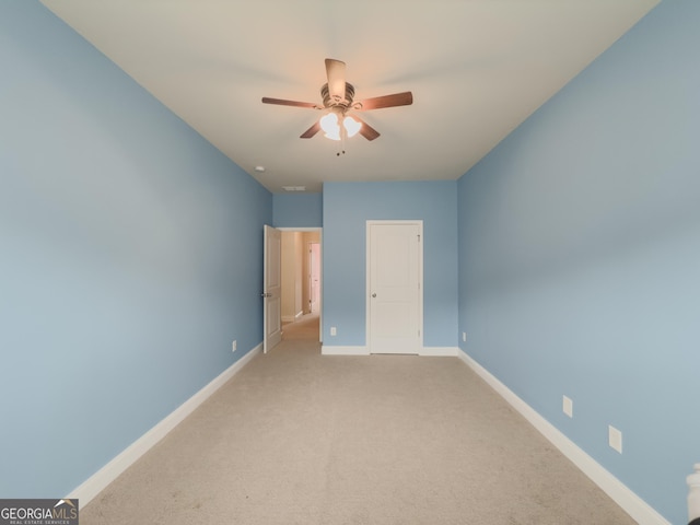 unfurnished bedroom with light carpet and ceiling fan