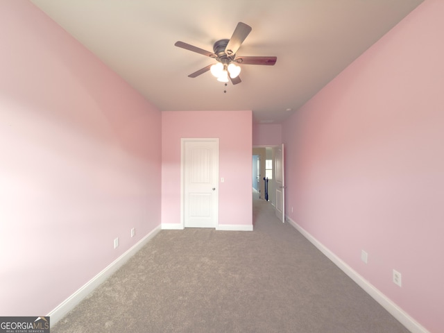 unfurnished room featuring light colored carpet and ceiling fan