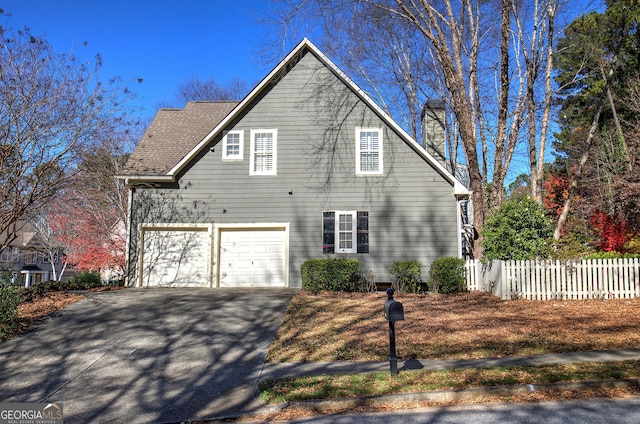 view of side of home featuring a garage