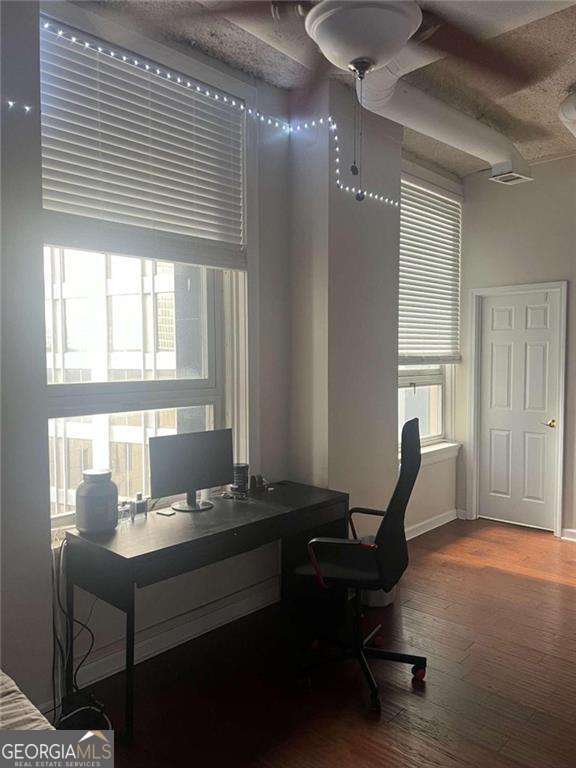 office space with ceiling fan and hardwood / wood-style flooring