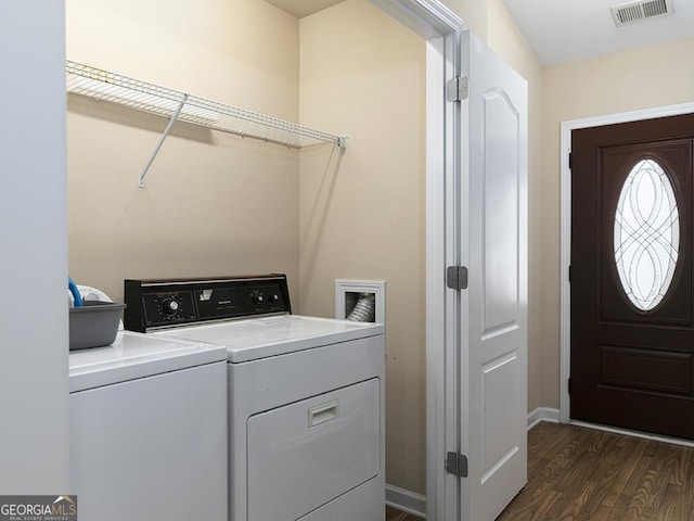 washroom with dark hardwood / wood-style floors and washer and clothes dryer