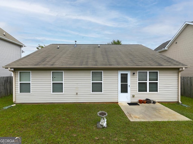 back of property featuring a yard and a patio