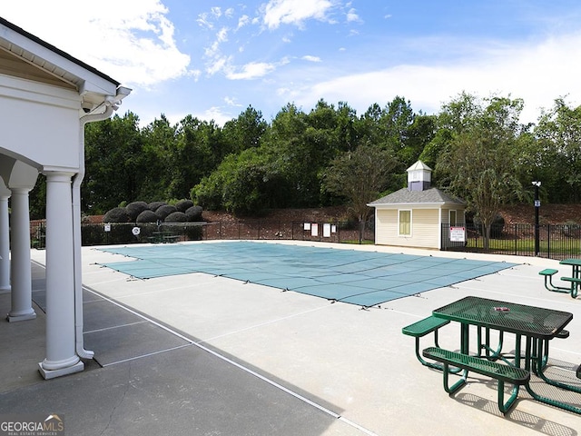 view of pool featuring a patio and an outdoor structure