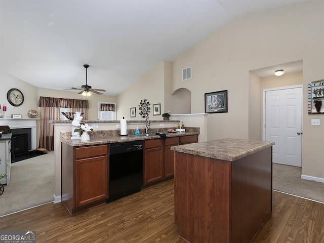 kitchen featuring ceiling fan, black dishwasher, dark hardwood / wood-style floors, lofted ceiling, and an island with sink